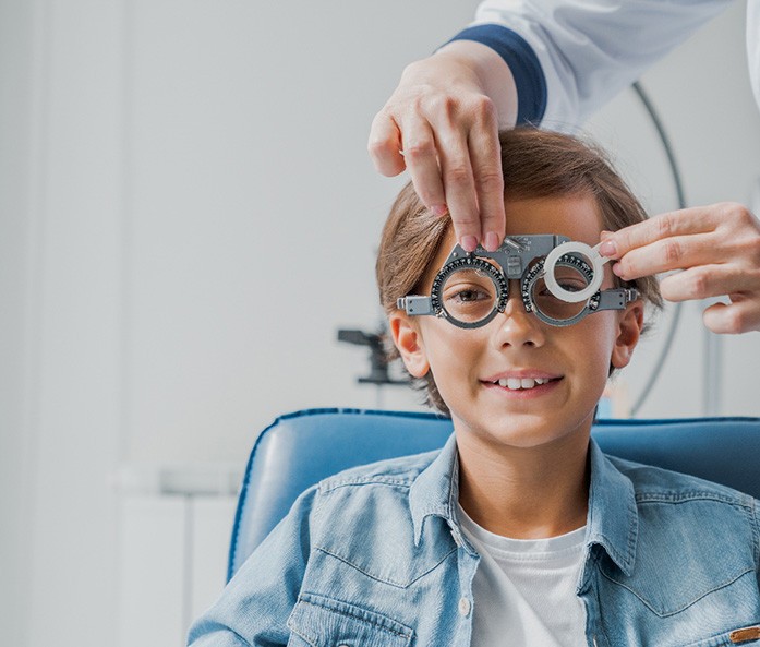 Little boy sitting in chair receiving comprehensive eye exam in Richmond