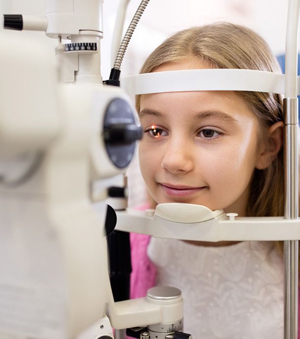 Little girl having light shined in eye for eye exam