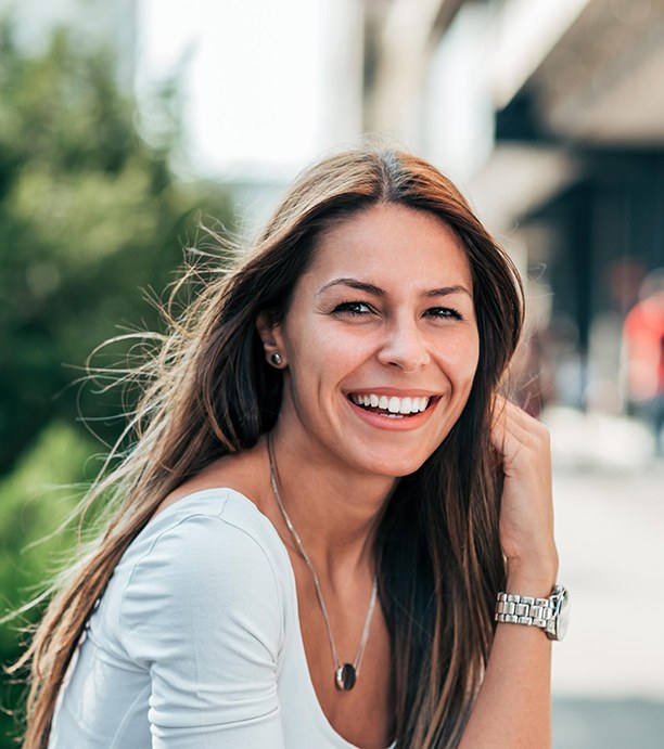 Woman sitting outside and smiling