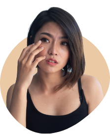 Woman holding her hand close to her eye