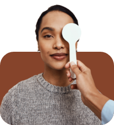 Optometrist covering one of womans eyes during an eye exam