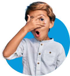 Surprised young boy covering his eyes but peeking through his fingers