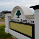 White outdoor sign reading Pecan Grove Plantation