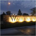 Outdoor sign lit up at night that reads Waterview Estates