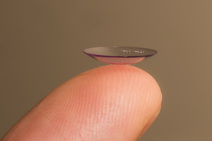 Close-up of finger balancing lens for Ortho-K