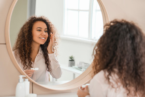 Woman about to put contact lens in eye