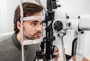 Bearded man having his eye examined