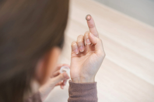 Woman taking a contact lens out of its box