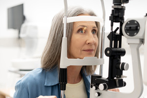 Woman receiving a slit-lamp eye examination
